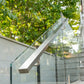 Brushed stainless cap rail along the top of a glass deck railing
