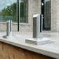 Brushed stainless spigot gripping a 12mm tempered glass railing panel