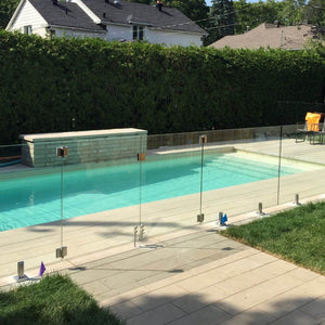 Glass railing surrounding a poolside deck
