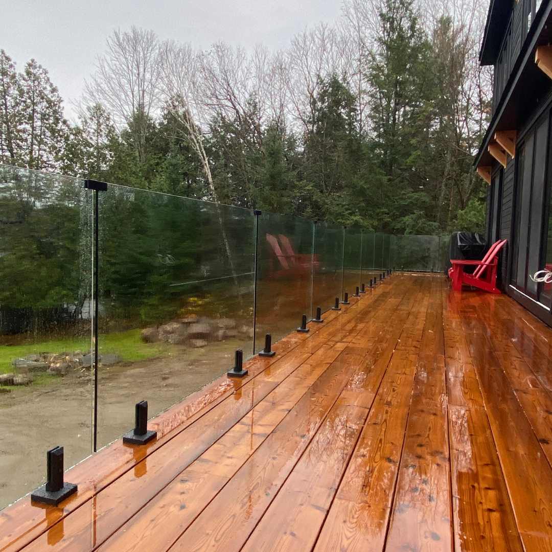 glass railing system installed on outdoor deck with modern design