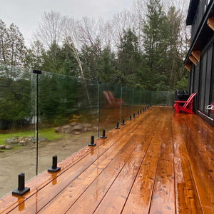 glass railing system installed on outdoor deck with modern design