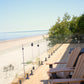 Glass deck railing with an open waterfront view