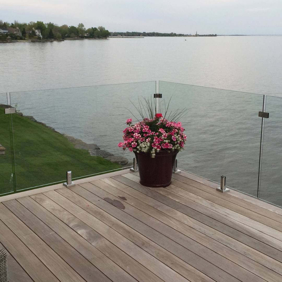 frameless glass railing installed on cottage deck with open lake view
