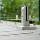 Brushed stainless spigot base plate anchored to a wood deck surface