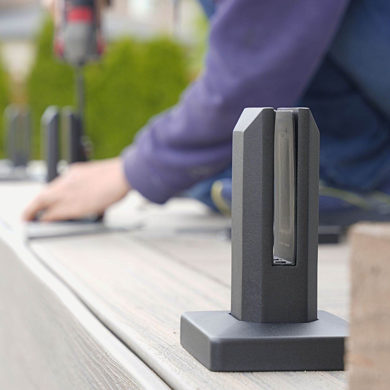 Matte black spigot core-mounted into a concrete surface