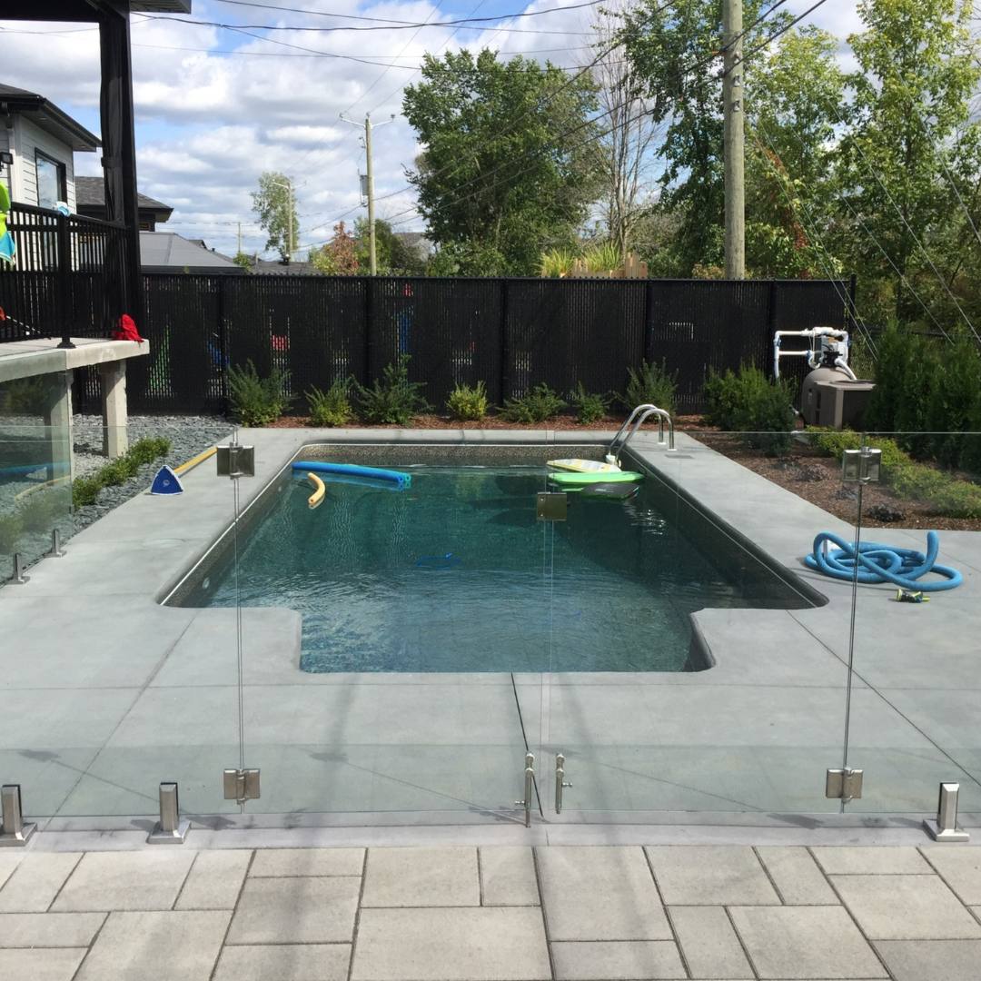 frameless glass railing installed around pool area for safety and modern look